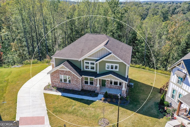 8555 Scenic Ridge Way, Ball Ground, GA 30107 - view of front of home featuring board and batten siding, a wooded view, and a front yard