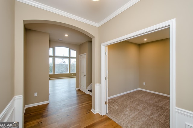 8555 Scenic Ridge Way, Ball Ground, GA 30107 - hallway featuring crown molding, arched walkways, and wood finished floors