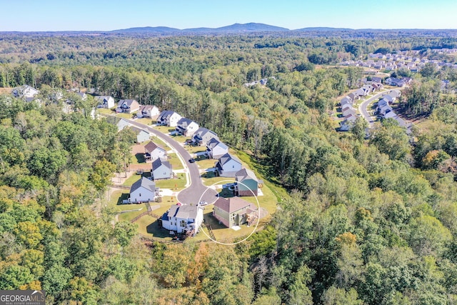 8555 Scenic Ridge Way, Ball Ground, GA 30107 - aerial overview of property's location featuring a heavily wooded area and nearby suburban area