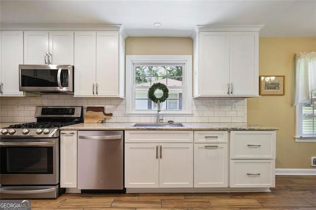 184 Rambo Pl SW, Marietta, GA 30064 - kitchen featuring stainless steel appliances, a sink, white cabinetry, and healthy amount of natural light