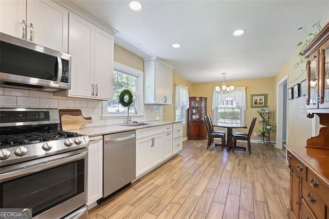 184 Rambo Pl SW, Marietta, GA 30064 - kitchen featuring stainless steel appliances, healthy amount of natural light, decorative backsplash, a chandelier, and recessed lighting