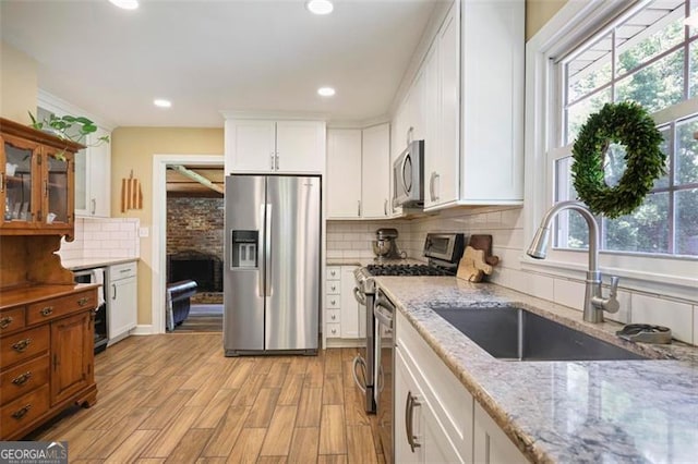 184 Rambo Pl SW, Marietta, GA 30064 - kitchen featuring stainless steel appliances, a sink, wine cooler, white cabinetry, and light stone counters