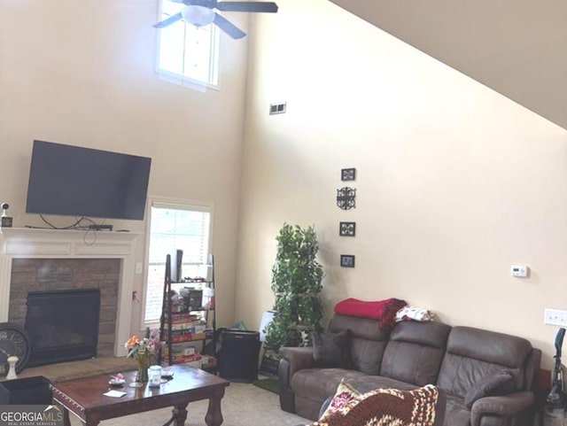 7613 Mockernut Way, Midland, GA 31820 - living room with a ceiling fan, a high ceiling, a fireplace with raised hearth, and carpet flooring