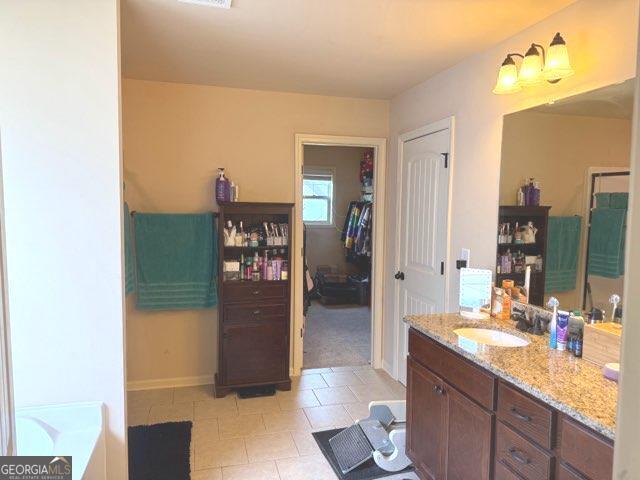 7613 Mockernut Way, Midland, GA 31820 - bathroom with baseboards, tile patterned flooring, vanity, and a tub to relax in