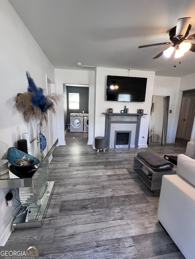 1132 SE Oak Knoll Ter, Atlanta, GA 30315 - living area with washing machine and clothes dryer, ceiling fan, a tiled fireplace, and wood finished floors