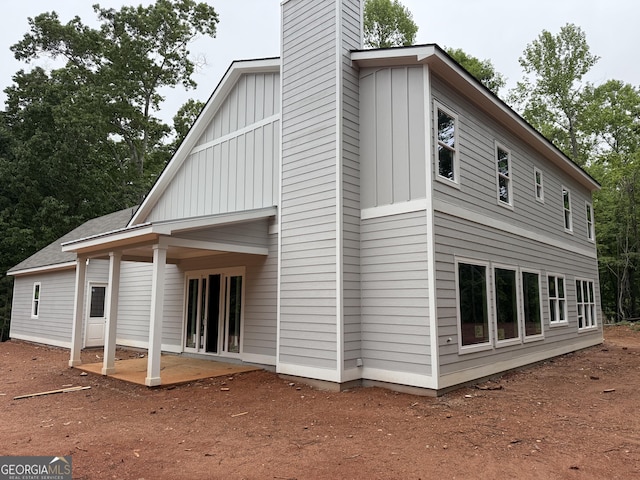 2135 Salem Church Rd, Jasper, GA 30143 - back of property with board and batten siding, a patio area, and a chimney