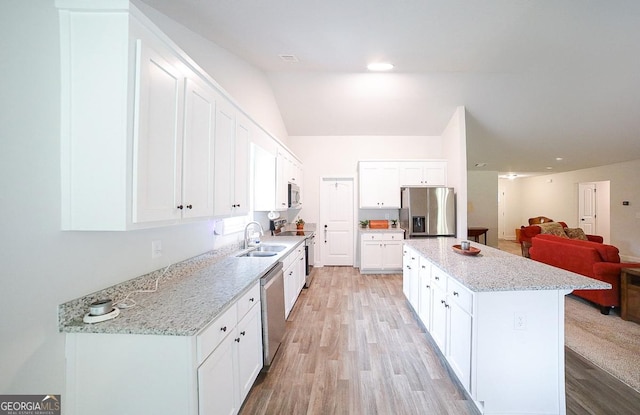 170 Kinsley Way, Statham, GA 30666 - kitchen featuring stainless steel appliances, open floor plan, a center island, light wood-style flooring, and white cabinets