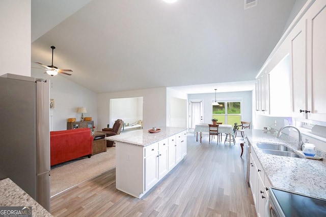 170 Kinsley Way, Statham, GA 30666 - kitchen with appliances with stainless steel finishes, light wood-style flooring, white cabinetry, light stone countertops, and lofted ceiling