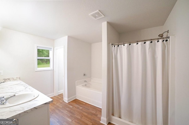 170 Kinsley Way, Statham, GA 30666 - full bath featuring wood finished floors, a bath, double vanity, and curtained shower