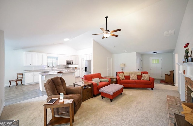 170 Kinsley Way, Statham, GA 30666 - living room featuring lofted ceiling, ceiling fan, a fireplace, and light colored carpet