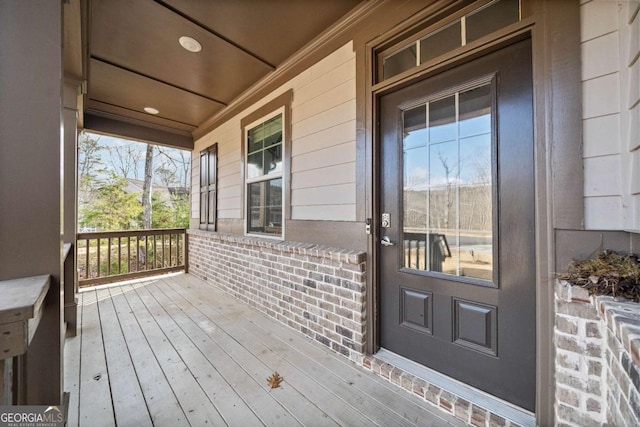 724 Broken Arrow, Waleska, GA 30183 - doorway to property featuring covered porch and brick siding