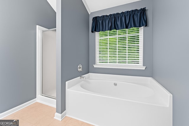 106 Kerby Cir, Braselton, GA 30517 - full bathroom with a stall shower, a garden tub, tile patterned flooring, vaulted ceiling, and baseboards
