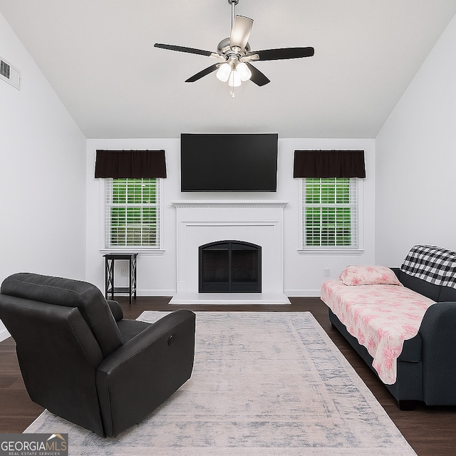 106 Kerby Cir, Braselton, GA 30517 - living area with wood finished floors, ceiling fan, a fireplace with raised hearth, vaulted ceiling, and baseboards