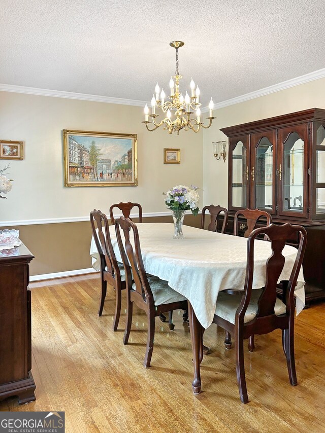 21 Picketts Rdg, Acworth, GA 30101 - dining area featuring light wood-type flooring, crown molding, a chandelier, and a textured ceiling
