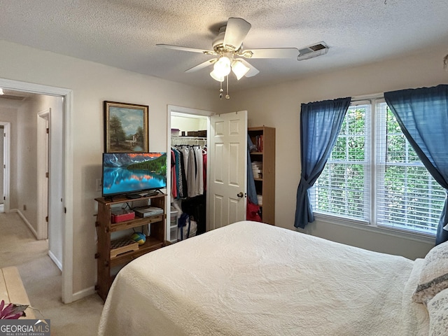 21 Picketts Rdg, Acworth, GA 30101 - carpeted bedroom featuring baseboards, a textured ceiling, a closet, a walk in closet, and ceiling fan