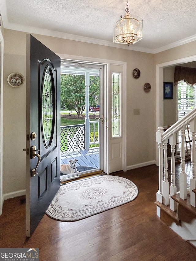 21 Picketts Rdg, Acworth, GA 30101 - foyer with a textured ceiling, a chandelier, wood finished floors, crown molding, and baseboards