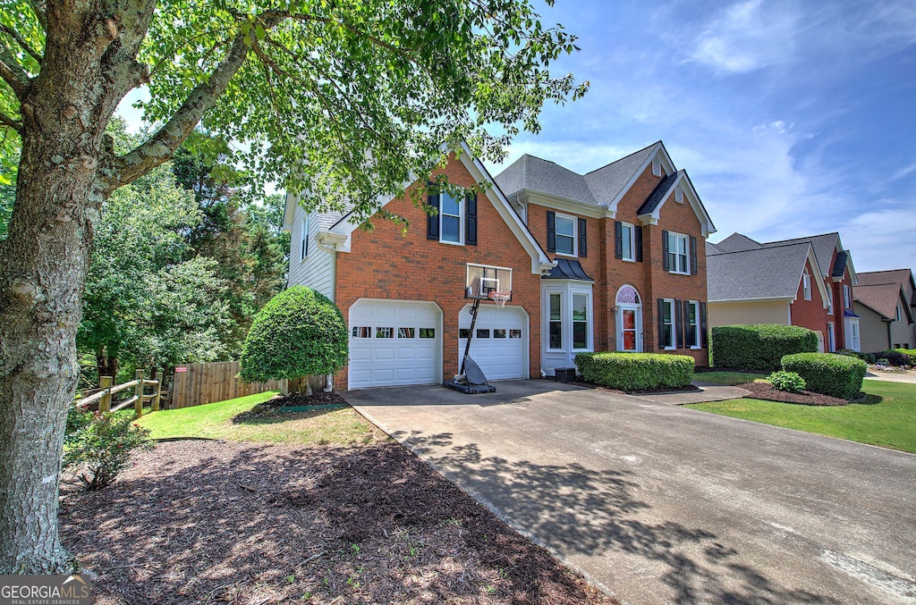 1124 Monarda Way NW, Acworth, GA 30102 - traditional-style house featuring concrete driveway, brick siding, and an attached garage