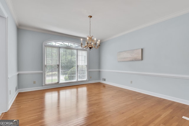 1285 Rivershyre Pkwy, Lawrenceville, GA 30043 - empty room featuring a chandelier, light wood-style floors, ornamental molding, and baseboards