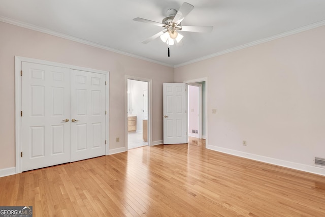 1285 Rivershyre Pkwy, Lawrenceville, GA 30043 - unfurnished bedroom featuring light wood-style flooring, crown molding, baseboards, ensuite bath, and a closet