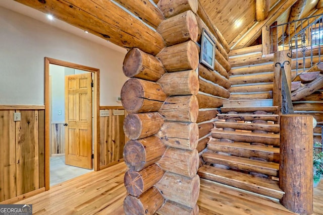 6487 W Old Highway 64 W, Warne, NC 28909 - staircase featuring wood finished floors, rustic walls, wainscoting, wooden ceiling with exposed beams, and recessed lighting