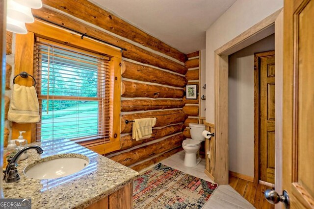 6487 W Old Highway 64 W, Warne, NC 28909 - bathroom featuring log walls, toilet, and vanity