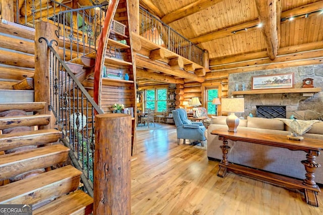 6487 W Old Highway 64 W, Warne, NC 28909 - living room with wood ceiling with exposed beams, wood finished floors, rustic walls, stairway, and high vaulted ceiling