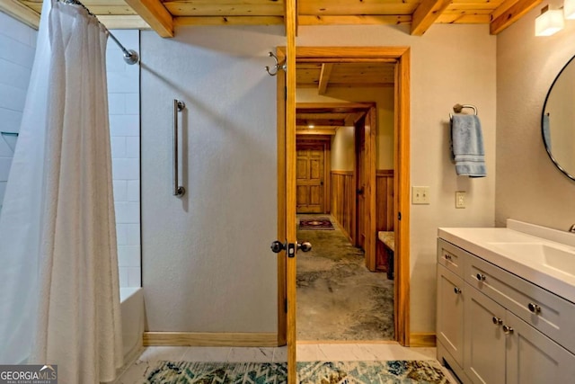 6487 W Old Highway 64 W, Warne, NC 28909 - full bathroom with vanity, shower / tub combo with curtain, baseboards, and beamed ceiling