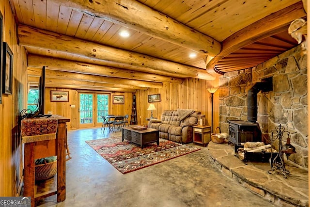 6487 W Old Highway 64 W, Warne, NC 28909 - living room with a wood stove, wood ceiling with exposed beams, and concrete floors