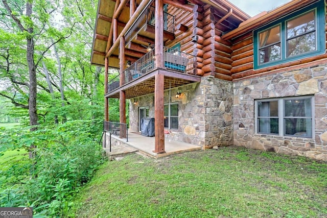 6487 W Old Highway 64 W, Warne, NC 28909 - back of property with stone siding, log exterior, a balcony, and a patio area