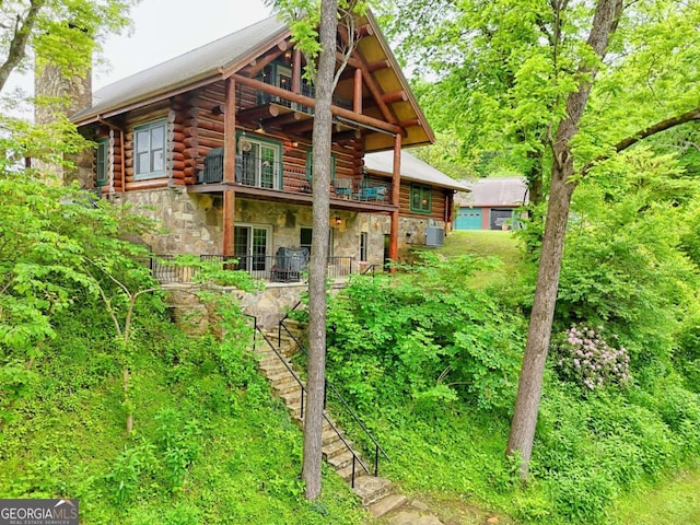 6487 W Old Highway 64 W, Warne, NC 28909 - rear view of house with stone siding, a chimney, log exterior, and a balcony