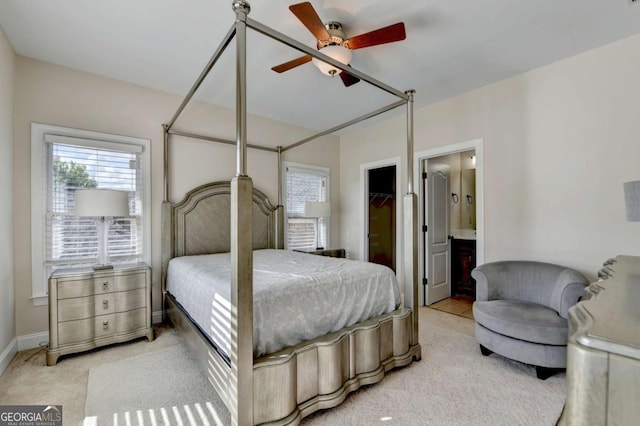 1054 Morgan Garner Dr SW, Lilburn, GA 30047 - carpeted bedroom with a spacious closet, ensuite bath, a ceiling fan, and baseboards