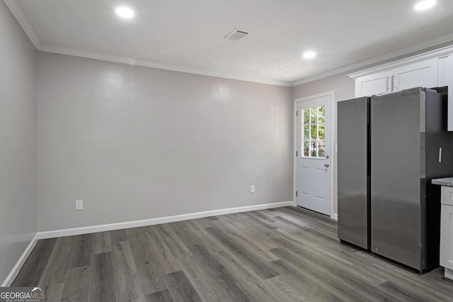 2894 Cushing Ct, Jonesboro, GA 30236 - kitchen with freestanding refrigerator, wood finished floors, white cabinetry, recessed lighting, and ornamental molding