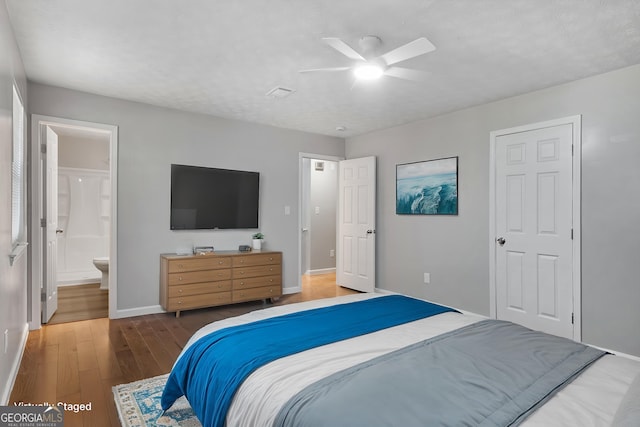 2894 Cushing Ct, Jonesboro, GA 30236 - bedroom with baseboards, wood finished floors, ensuite bath, and ceiling fan