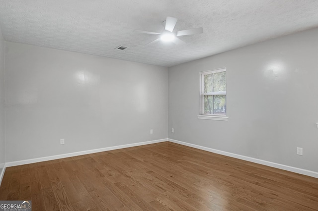 2894 Cushing Ct, Jonesboro, GA 30236 - spare room with ceiling fan, wood finished floors, a textured ceiling, and baseboards