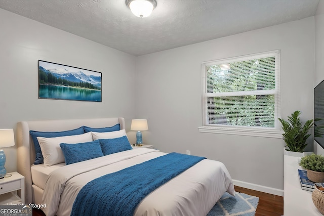 2894 Cushing Ct, Jonesboro, GA 30236 - bedroom featuring baseboards, wood finished floors, and a textured ceiling