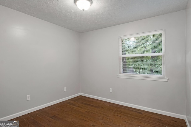 2894 Cushing Ct, Jonesboro, GA 30236 - spare room featuring dark wood finished floors, a textured ceiling, and baseboards