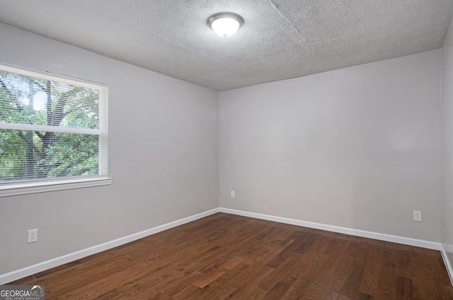 2894 Cushing Ct, Jonesboro, GA 30236 - empty room featuring dark wood-style flooring, baseboards, and a textured ceiling