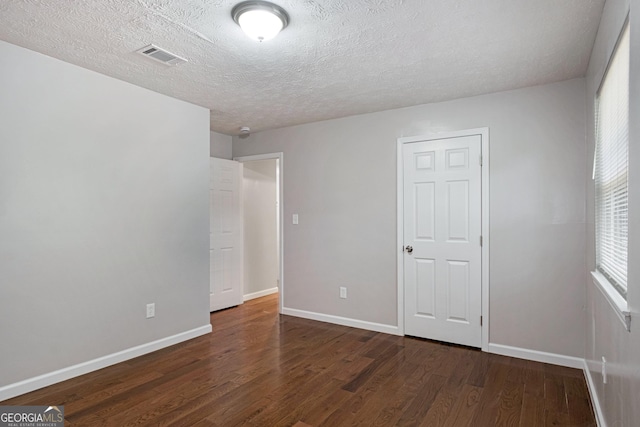 2894 Cushing Ct, Jonesboro, GA 30236 - unfurnished bedroom featuring wood finished floors, baseboards, and a textured ceiling