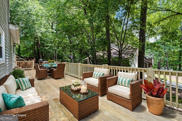 2894 Cushing Ct, Jonesboro, GA 30236 - wooden deck with outdoor lounge area, outdoor dining space, and view of wooded area
