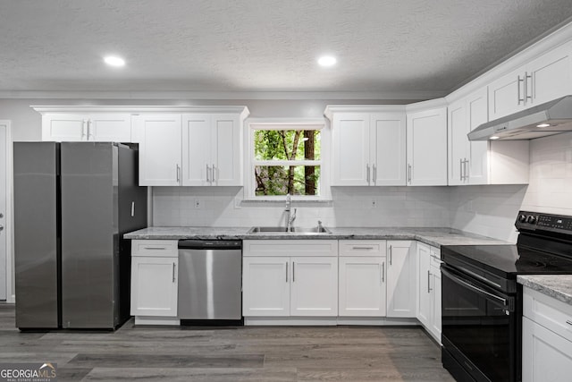 2894 Cushing Ct, Jonesboro, GA 30236 - kitchen with stainless steel appliances, a sink, under cabinet range hood, white cabinetry, and a textured ceiling
