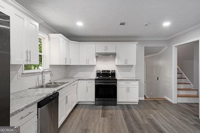 2894 Cushing Ct, Jonesboro, GA 30236 - kitchen featuring stainless steel appliances, a sink, under cabinet range hood, dark wood-type flooring, and white cabinetry