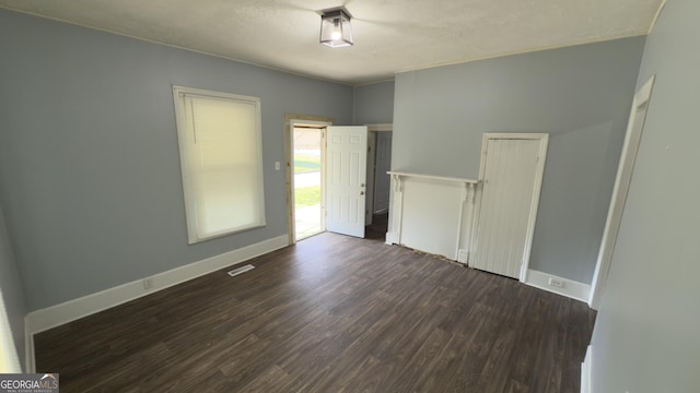 3440 Brookdale Ave, Macon, GA 31204 - unfurnished bedroom with dark wood-style floors and baseboards