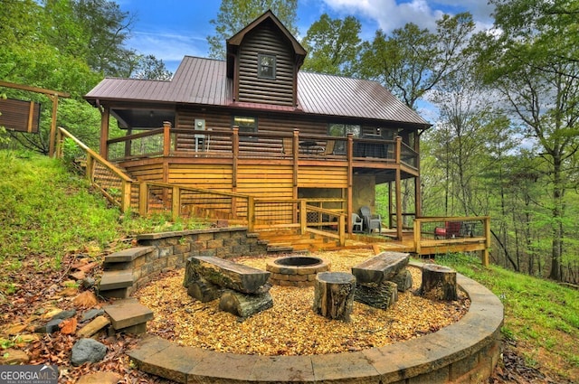 294 Oakwood Trl, Mineral Bluff, GA 30559 - back of house featuring a fire pit, a wooden deck, metal roof, stairs, and faux log siding