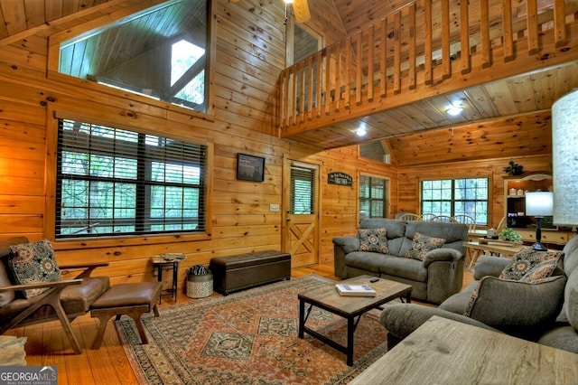 294 Oakwood Trl, Mineral Bluff, GA 30559 - living room with hardwood / wood-style floors, wood walls, and high vaulted ceiling