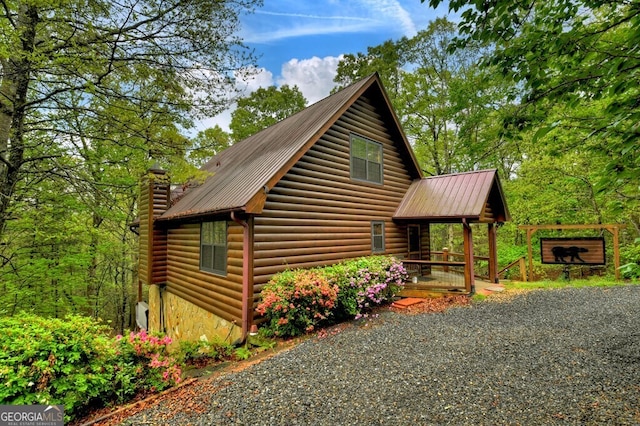 294 Oakwood Trl, Mineral Bluff, GA 30559 - view of home's exterior with metal roof, a chimney, and stone siding