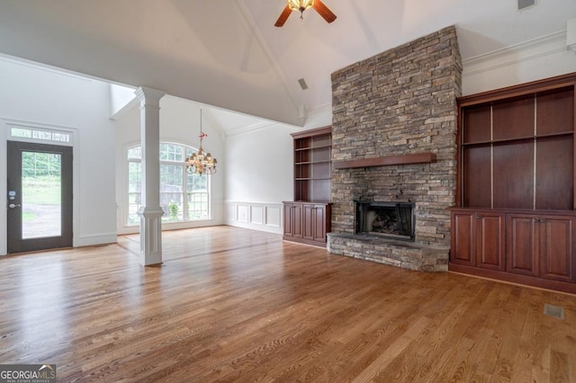 5620 Barnett Shoals Rd, Athens, GA 30605 - unfurnished living room featuring high vaulted ceiling, a chandelier, a fireplace, ceiling fan, and light wood-style floors