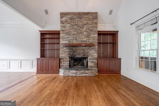 5620 Barnett Shoals Rd, Athens, GA 30605 - unfurnished living room featuring ornamental molding, wood finished floors, a fireplace, and lofted ceiling