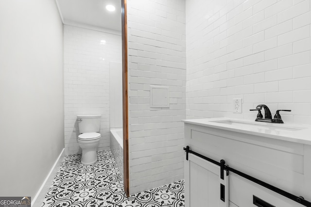 107 S Mulberry St, Statesboro, GA 30458 - full bathroom with tile walls, vanity, toilet, baseboards, and tile patterned floors
