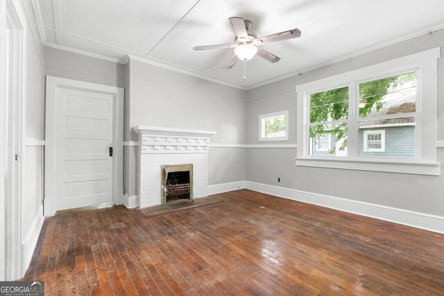 107 S Mulberry St, Statesboro, GA 30458 - unfurnished living room featuring ceiling fan, a brick fireplace, wood-type flooring, and crown molding
