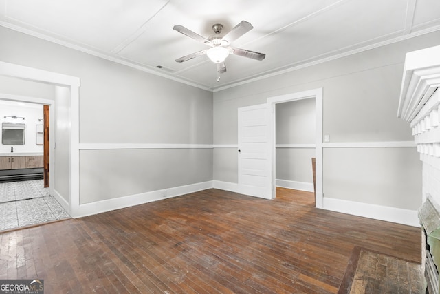 107 S Mulberry St, Statesboro, GA 30458 - unfurnished bedroom featuring hardwood / wood-style flooring, ornamental molding, baseboards, a ceiling fan, and connected bathroom